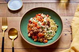 Greek grain bowl with lamb ragout and lemon yogurt sauce