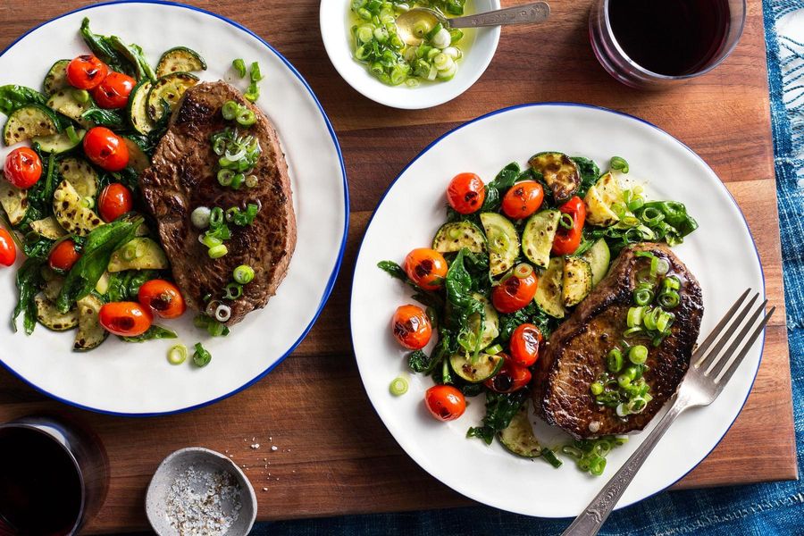 Steak and charred vegetables with basil and lemon