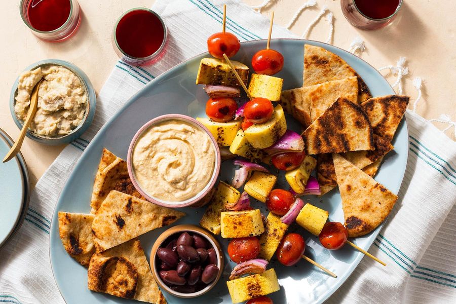 Summer vegetable skewers with baba ganoush, feta dip, and flatbread