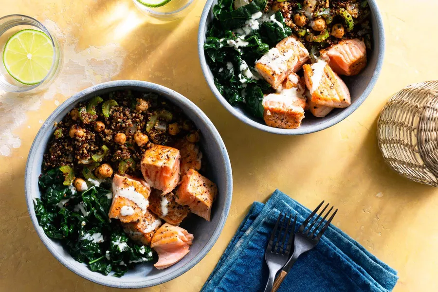 Salmon and quinoa bowls with wilted greens and citrus dressing