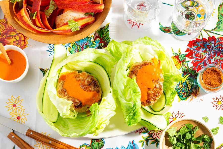 Lettuce-wrapped burgers with spicy chraime carrot salad