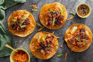 Korean BBQ tostadas with pollock, charred scallions, and carrot slaw