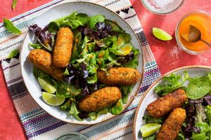 Zucchini-chickpea köfte over mixed greens with spicy chile-mango dressing