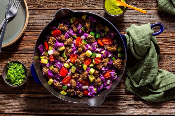 Italian sausage and vegetable skillet with spicy green harissa