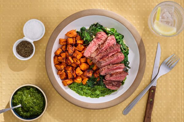 Steaks with chimichurri and harissa-roasted sweet potatoes