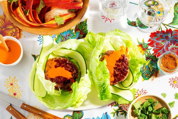 Lettuce-wrapped turkey burgers with spicy chraime carrot salad