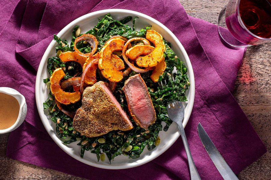 Cornmeal-crusted lamb chops and roasted delicata squash over kale salad