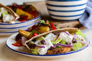 Tofu burger pita pockets with Greek salad, tzatziki, and potato hash