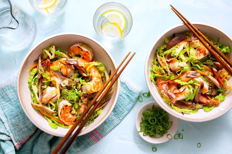 Egg roll in a bowl with stir-fried mushrooms, carrots, and cabbage