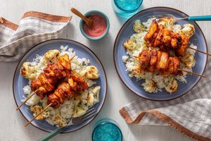 Tandoori-style chicken skewers with cauliflower over lemony rice