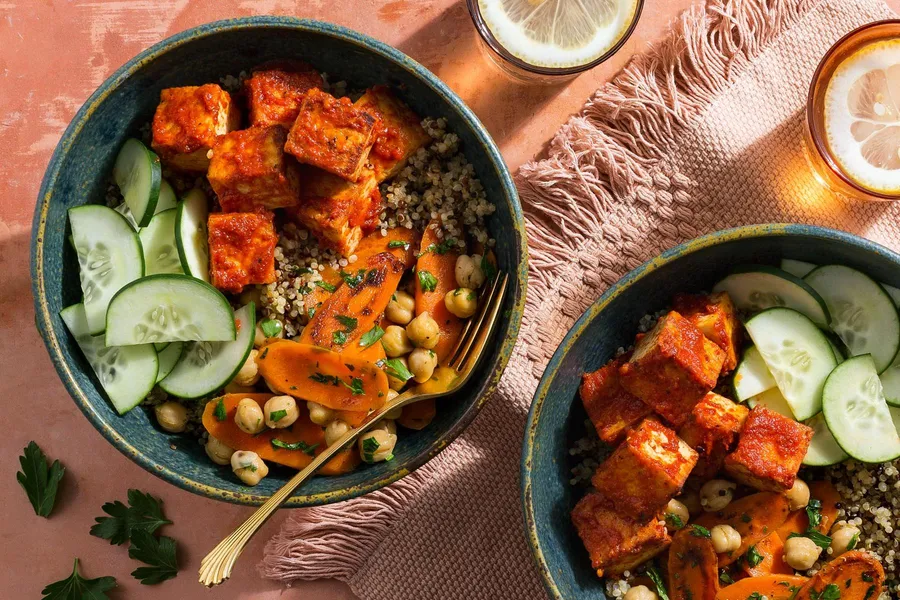 Spicy harissa tofu and quinoa bowls with carrots and chickpeas