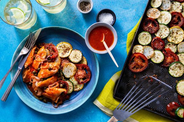 Tomato-braised pollock over roasted zucchini and new potatoes