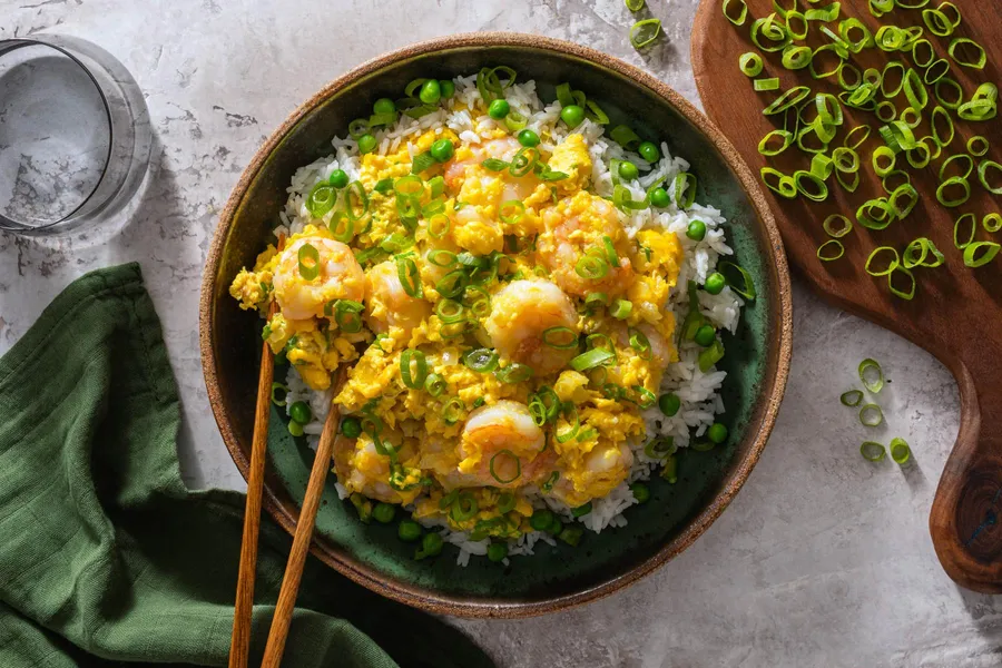 Chinese-style silky scrambled eggs with shrimp over rice and peas