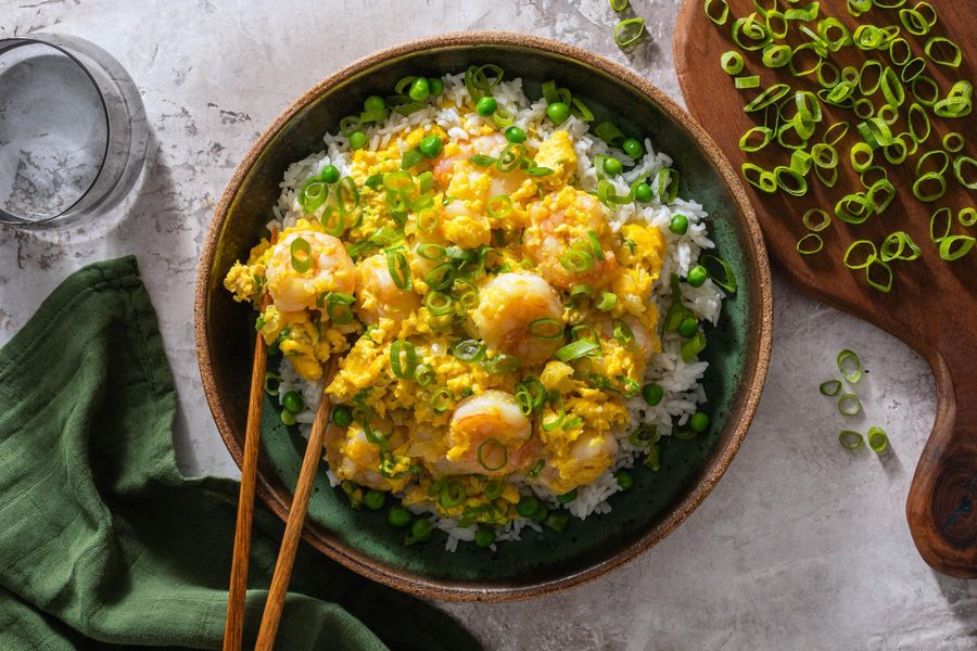 Chinese-style silky scrambled eggs with shrimp over rice and peas