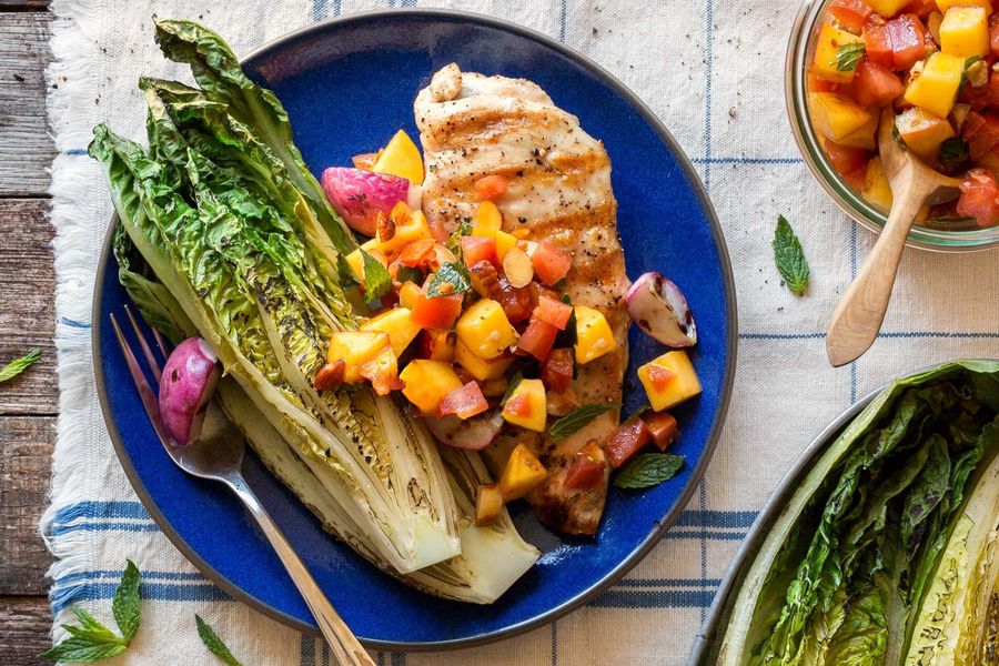 Chicken breasts with charred romaine and mango-almond salsa