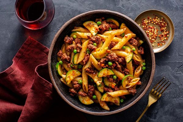 Turkey Bolognese with penne rigate, zucchini, and peas