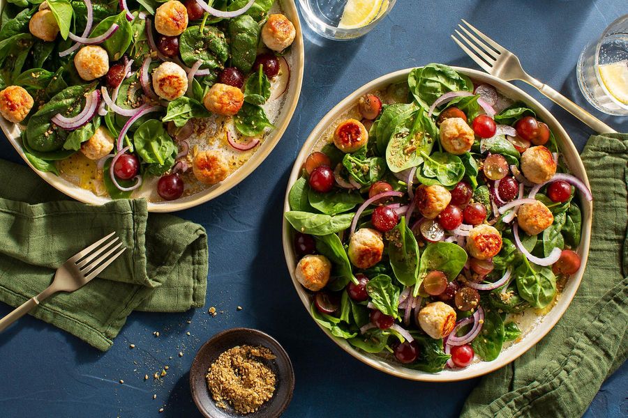 Kefta-spiced meatballs with spinach-grape salad and pumpkin seed dukkah