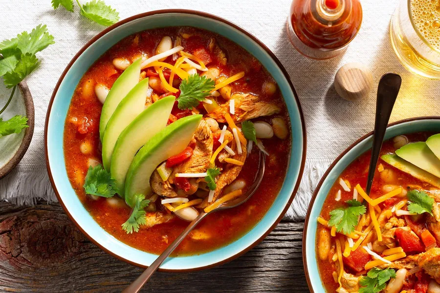 Chicken and white bean chili with avocado and cheese