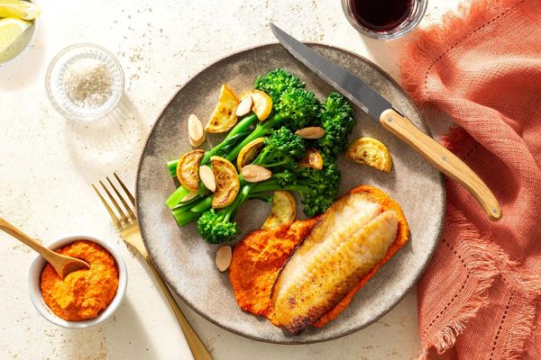 Steaks and romesco with baby broccoli, summer squash, and almonds