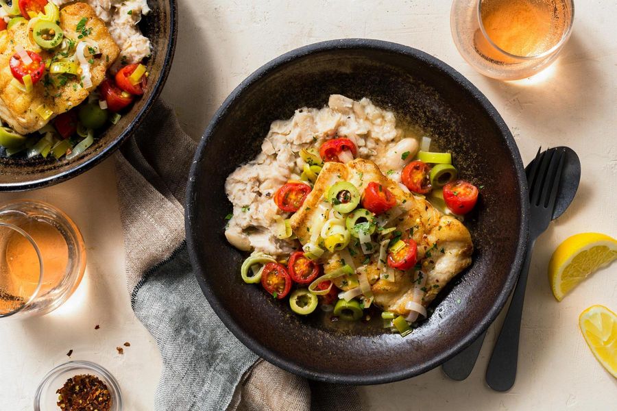 Braised cod and vegetables over smashed white beans