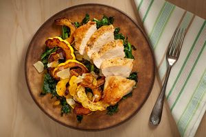 Chicken breasts with roasted delicata squash, wilted kale, and raisins
