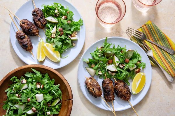 Greek beef skewers with arugula-pear salad and hazelnuts