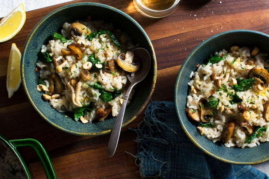 Three-mushroom risotto with wilted greens and hazelnuts