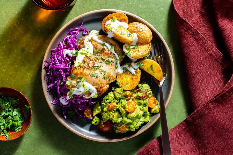 Chicken with crispy potatoes, avocado mash, and honey-lime yogurt