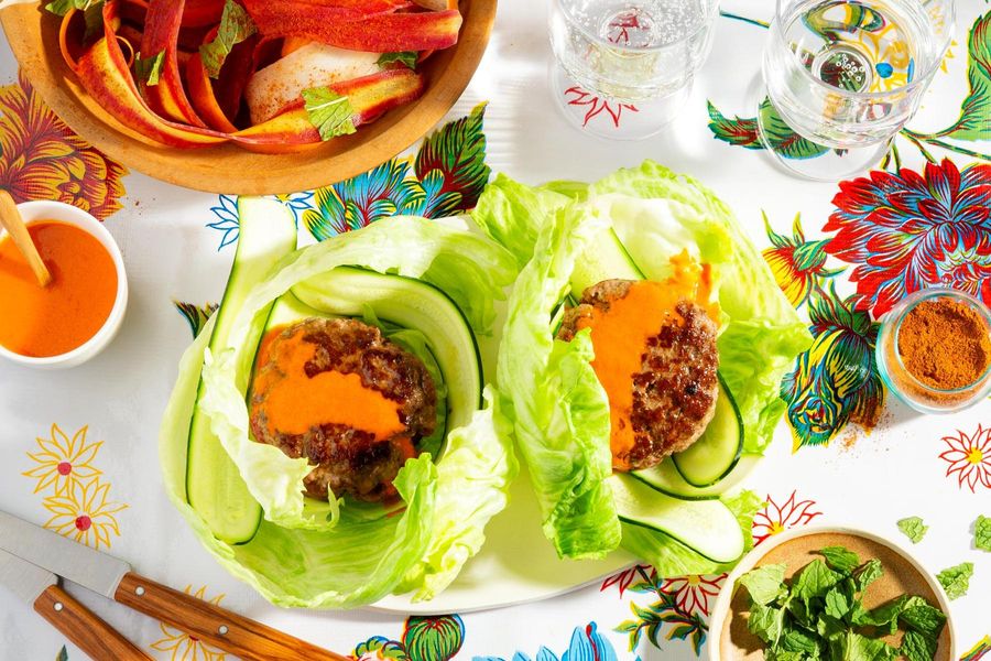 Lettuce-wrapped burgers with spicy chraime carrot salad