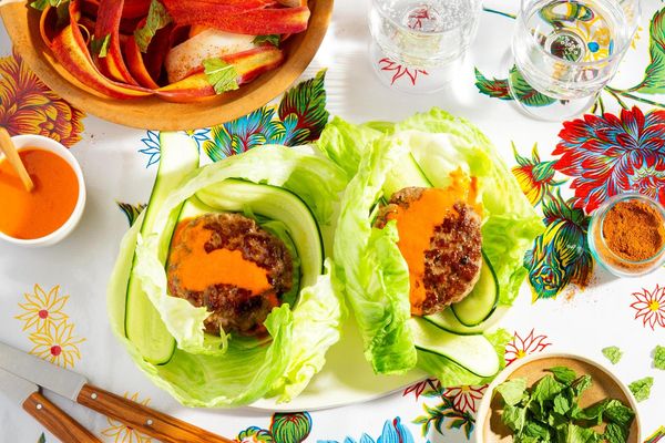 Lettuce-wrapped turkey burgers with spicy chraime carrot salad