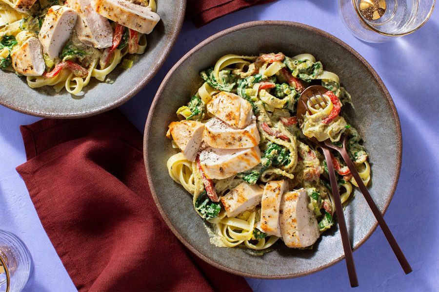 Chicken fettuccine with roasted peppers, spinach, and “creamy” pesto