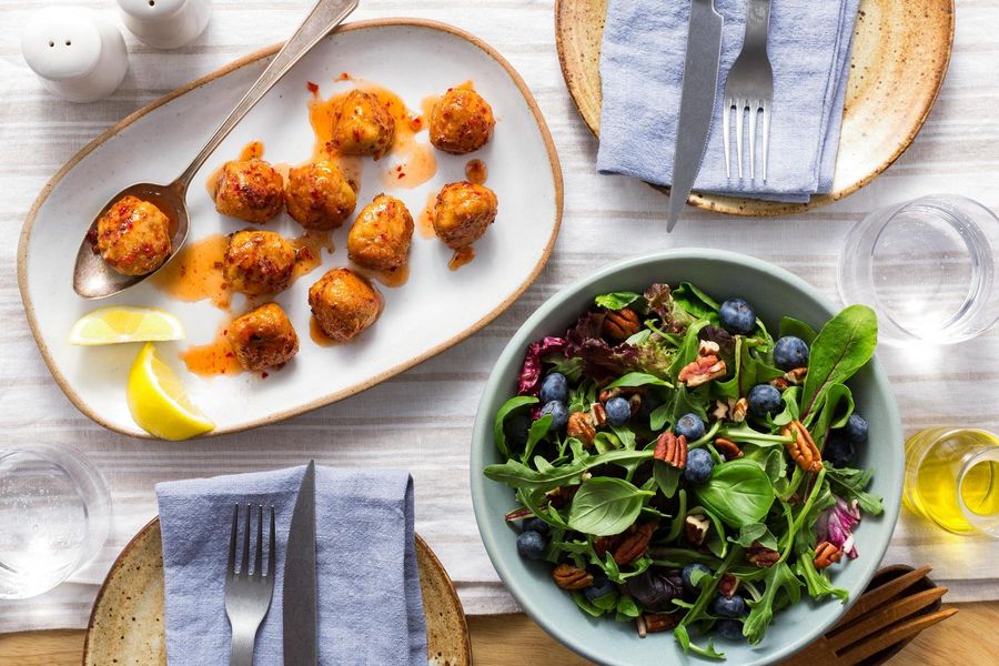 Sweet and spicy chicken meatballs with blueberry-pecan salad