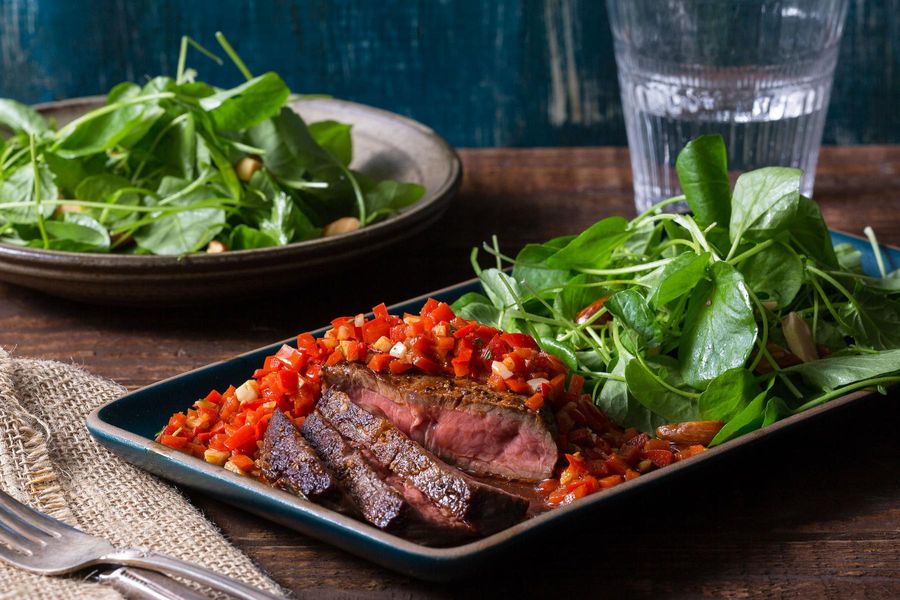 Pan-seared steak with ajvar red pepper relish and watercress