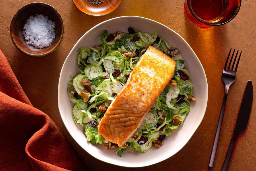 Seared salmon with Brussels sprout and dried cranberry Caesar salad