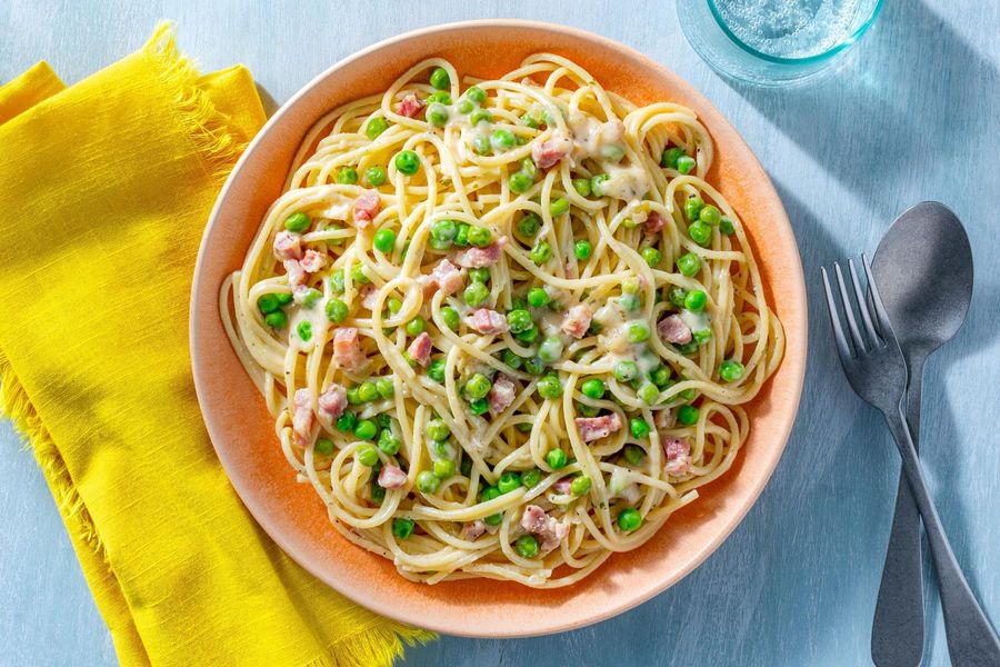 Creamy spaghetti carbonara with pancetta and sweet peas