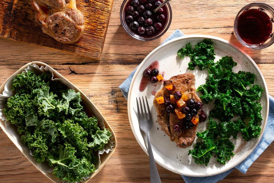 Pork blade steaks with blueberry-apricot sauce and sautéed kale