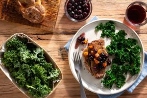 Pork blade steaks with blueberry-apricot sauce and sautéed kale