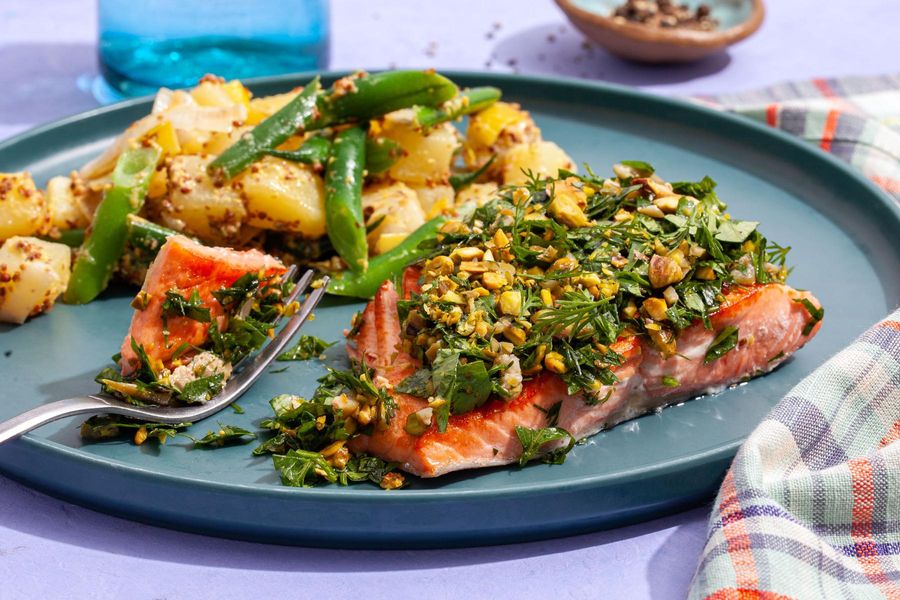 Salmon with pistachio-herb dressing and warm potato salad