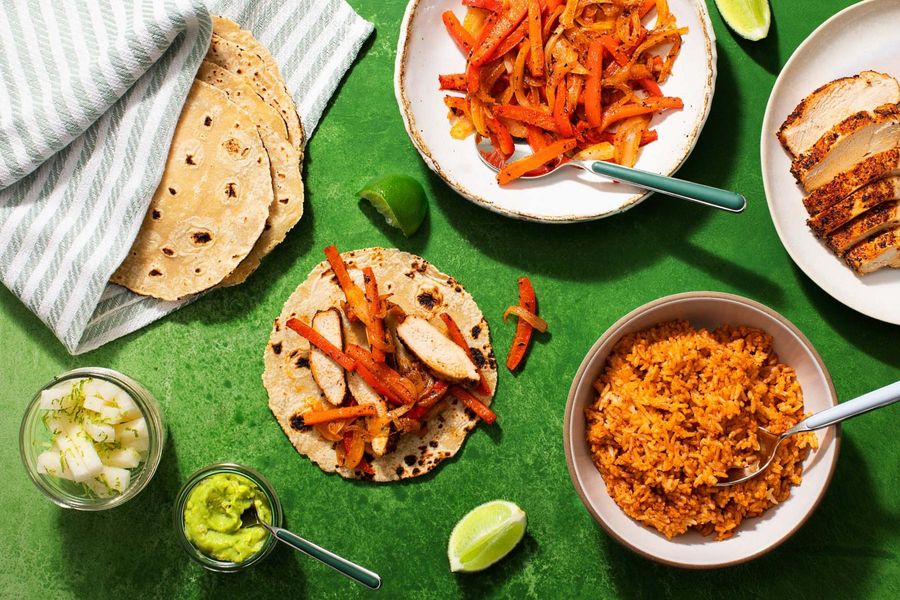 Chicken fajitas with chipotle rice, jicama sticks, and guacamole