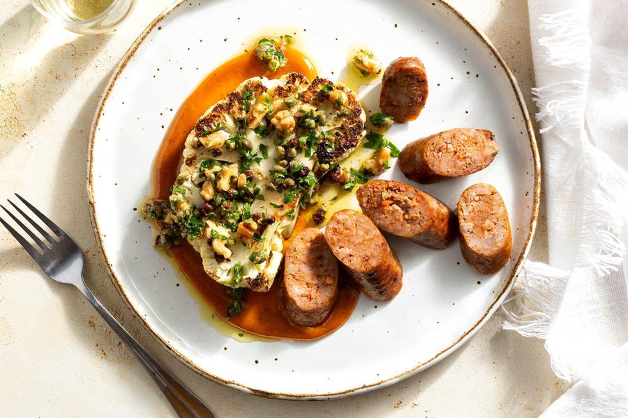 Sausages and cauliflower “steaks” with gremolata and spicy tahini