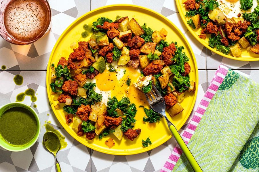 Kale and potato hash with runny eggs and spicy green harissa