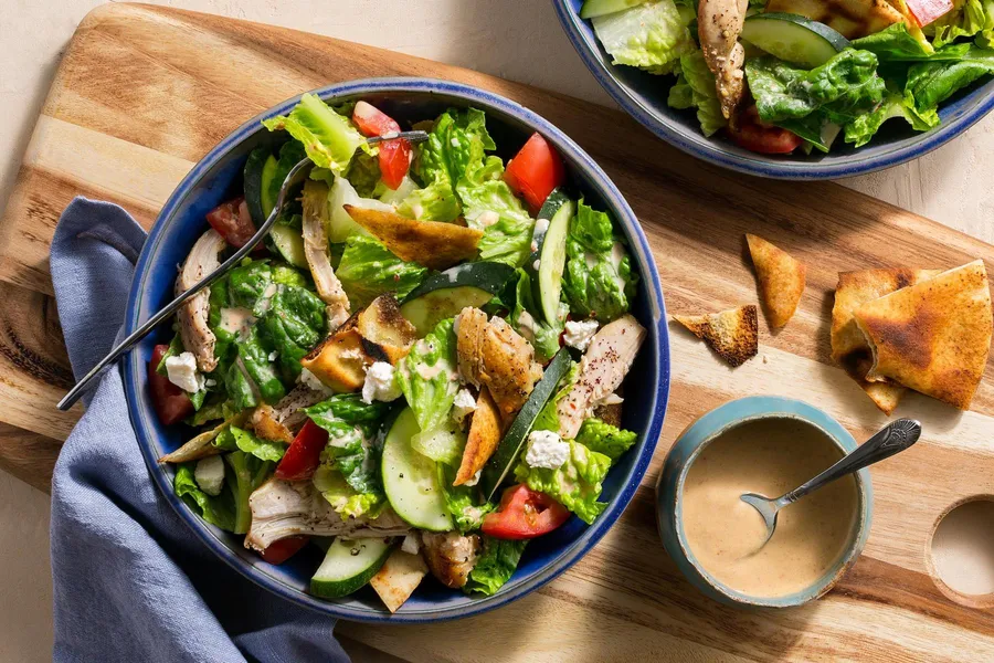 Chicken shawarma salad with pita chips and lemon-tahini dressing