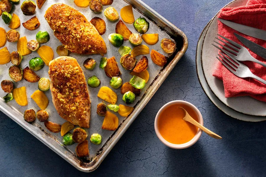 Roasted chicken breasts and fall vegetables with red pepper vinaigrette