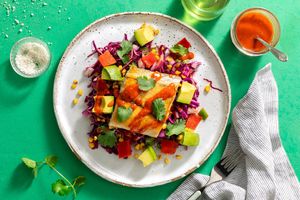 Barramundi with New Mexican chile sauce over warm corn and avocado salad