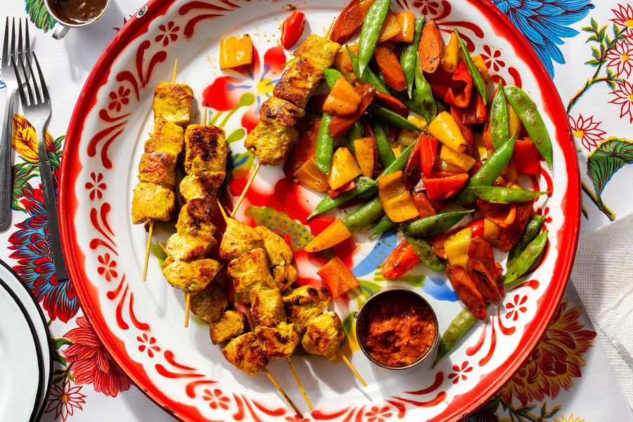 Skewered chicken satay with garlic vegetables and cashew dipping sauce