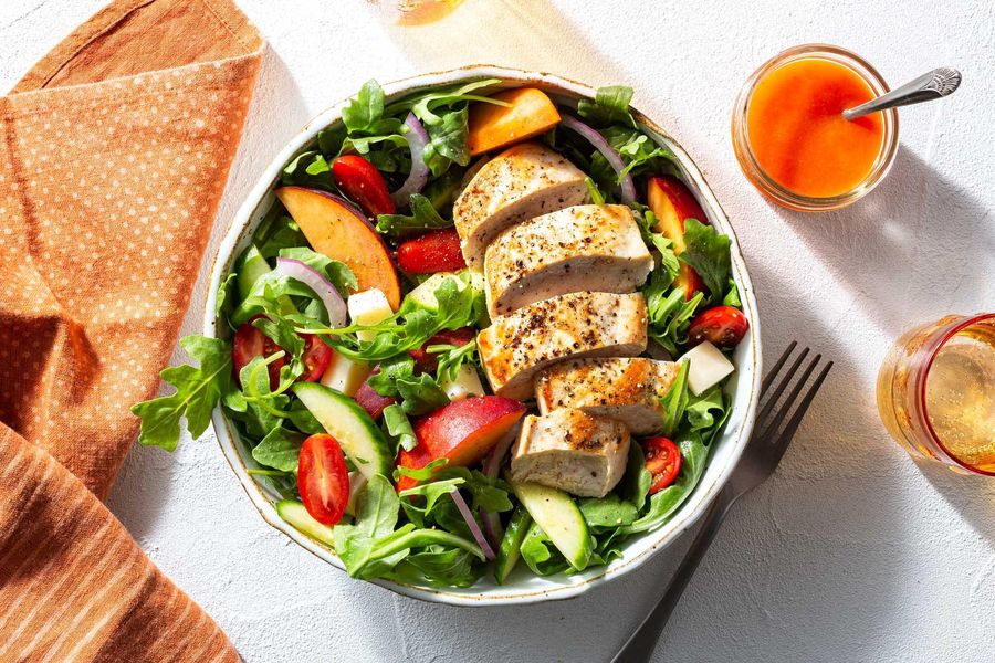 Chicken breasts with peach caprese salad and red pepper vinaigrette