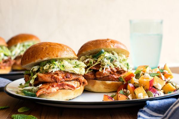 Barbacoa chicken sliders with cabbage slaw and peach-feta salad