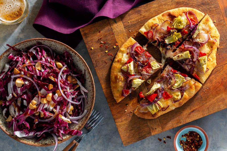 Artichoke and fresh mozzarella pizza with radicchio-hazelnut salad