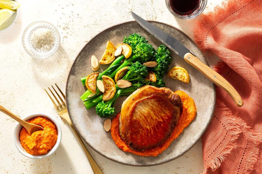 Steaks and romesco with baby broccoli, summer squash, and almonds