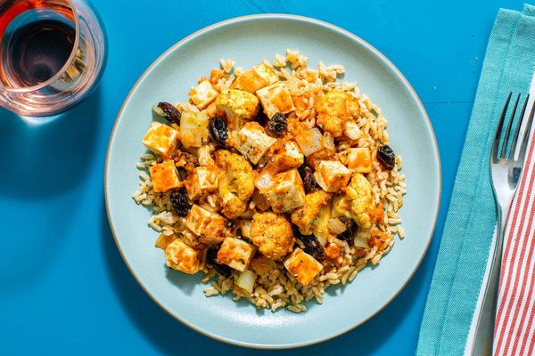 Chili-spiced tofu biryani with cauliflower, brown rice, and raisins